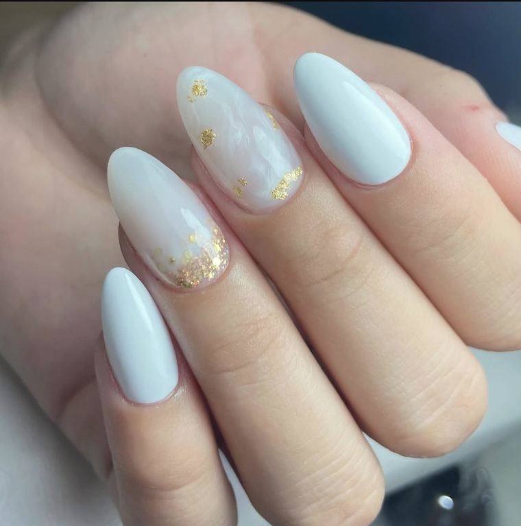 Uñas almendradas en azul claro con detalles de pan de oro